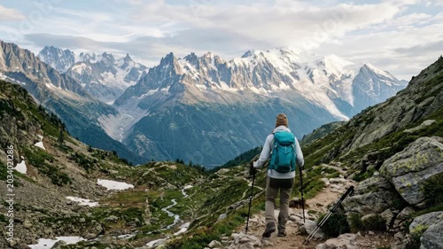 Amazing view on Monte Bianco mountains range with tourist on a foreground. Vallon de Berard Nature Preserve, Chamonix, Graian Alps, premium travel landscape stock photo, scenic depth, natural