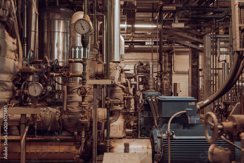 Canvas Print Industrial pipeline system with pumps and pressure gauges inside factory