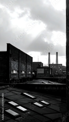 Moody Industrial Rooftops Under Dramatic Cloudy Sky in Urban District