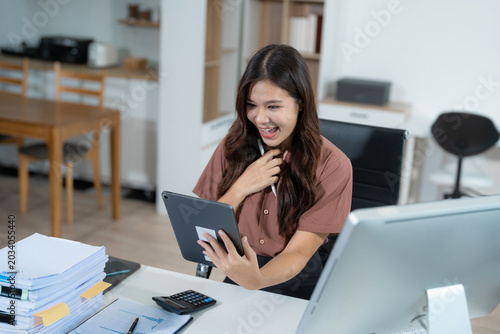 Bild auf Leinwand Overjoyed, Asian female businessman celebrates a financial bonus.