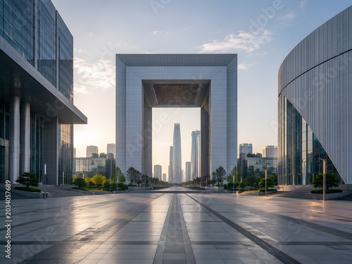 Modern architectural gateway frames city skyline at sunrise with golden light