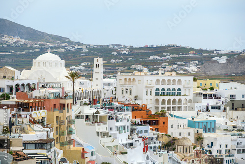 Tourism storefronts and pedestrians in Fira