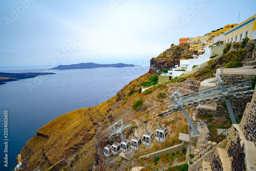 Fira caldera view with white houses and cloudy sky