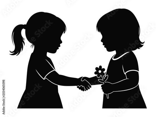 Silhouette of two young girls exchanging a flower and shaking hands