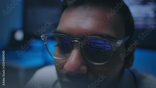 IT Professional Focusing on Data Stream with Eyewear Reflection