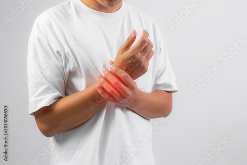 Tableau sur toile Person holding wrist with visible red inflamed area indicating possible injury o