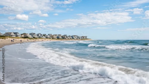 Coastal houses in the distance with waves rolling along Hampton Beach, New Hampshire, serene shoreline scene for seaside travel, vacation homes and Atlantic coast atmosphere themes natural light,