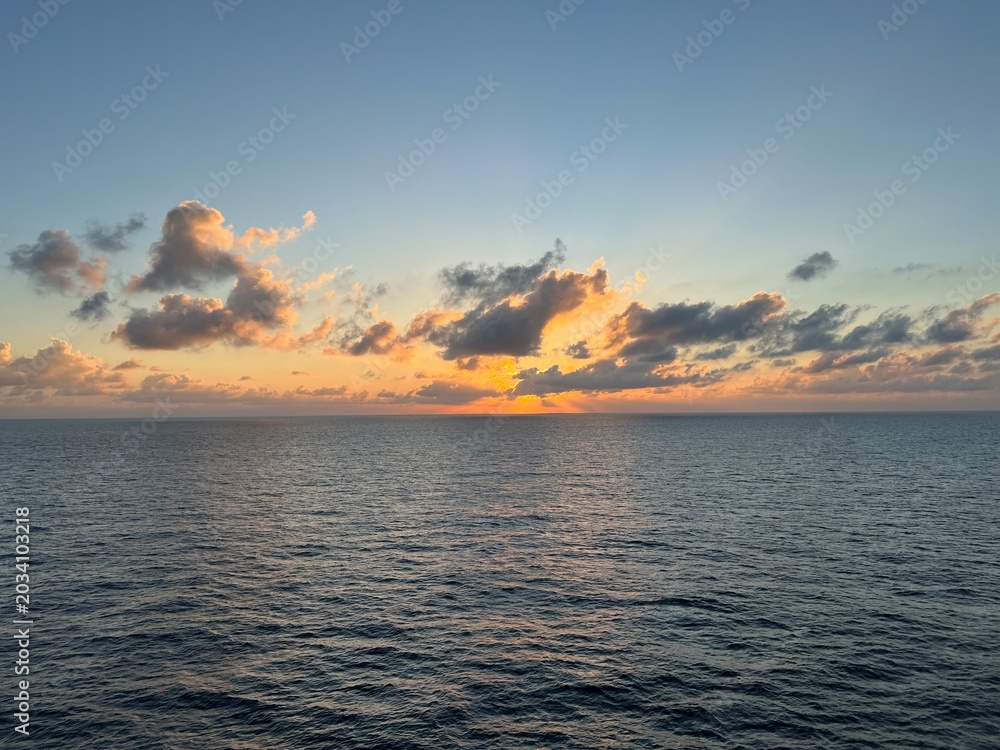 Fototapeta premium Tropical sunset with glowing clouds over the sea