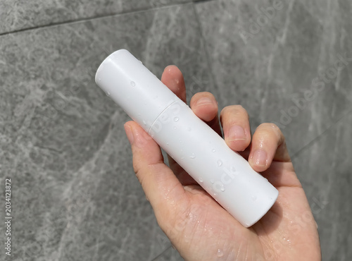 Close Up Hand Holding White Cosmetic Tube – Skincare Beauty Product Photography on Clean Background