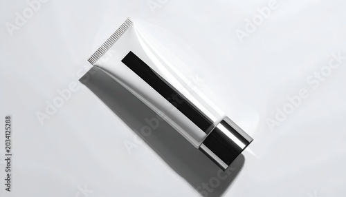 Minimalist shot of a partially translucent white tube against a white surface, with a shadow