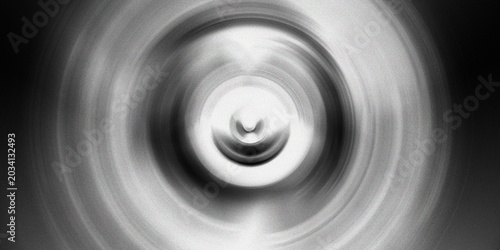 Abstract radial motion blur background with circular grey concentric rings creating artistic speed effect for modern wall decor.