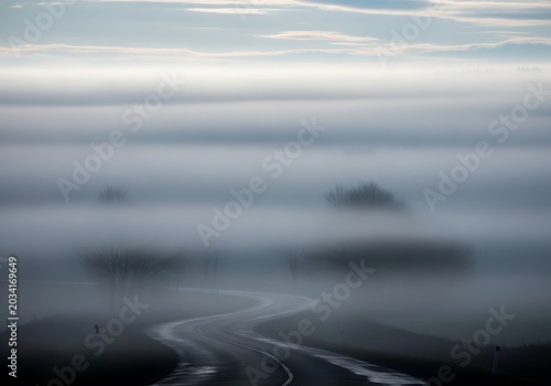 Misty Mountain Landscape with Foggy Atmosphere and Rolling Hills.