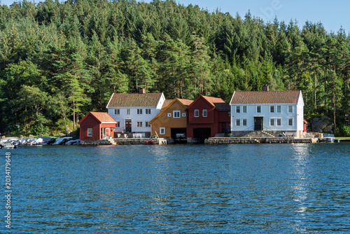 Scandinavian harbor community with colorful waterfront houses, small marina and quiet coastal village atmosphere near Lindesnes Lighthouse in Norway for tourism and Nordic living