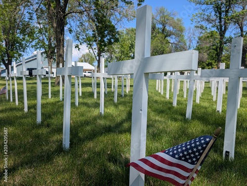Canvas Print White crosses set up in a park to honor fallen American veterans for Memorial Day in a rural Midwestern city