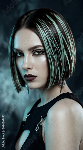 Edgy Caucasian woman with sleek dark espresso bob hair and green highlight wearing graphic eyeliner in moody futuristic studio lighting