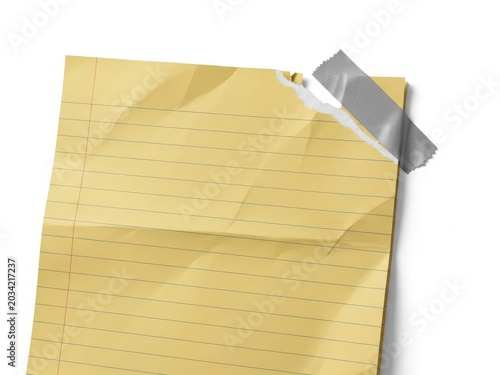 Crumpled yellow lined paper sheet with torn edge and grey adhesive tape on white surface