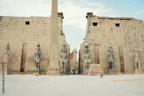 Photography The magnificent entrance pylon of Luxor Temple featuring the ancient Egyptian obelisk and colossal statues of Ramesses II, Egypt