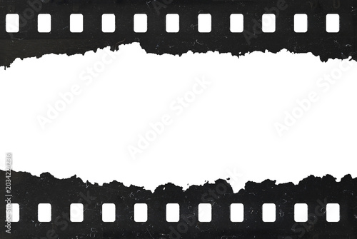 Tattered celluloid filmstrip with natural rough dust and scratches