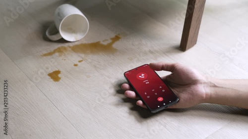 Unconscious man lying on the floor after calling emergency number 112 for help