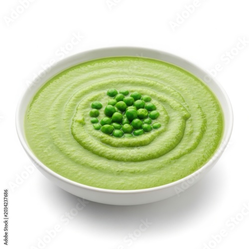White bowl containing green pea soup with fresh peas in the center
