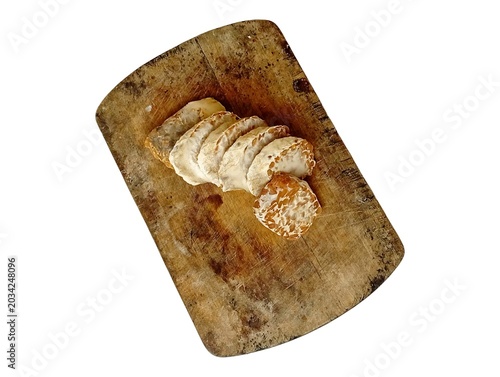 Traditional fermented tempeh slices known as tempe busuk on a rustic wooden cutting board isolated on white background, Indonesian fermented soybean food ingredient