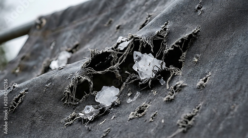Damaged fabric with hailstones