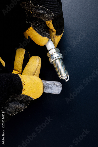 Gapping feeler gage and spark plug