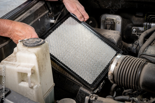 Mechanic installs a fresh clean air filter