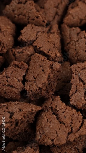 Heap of broken Chocolate cookies close up, rotation