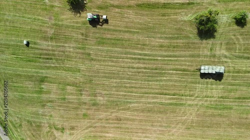 Aerial View of Tractor Working on Hay Field in Rural Countryside