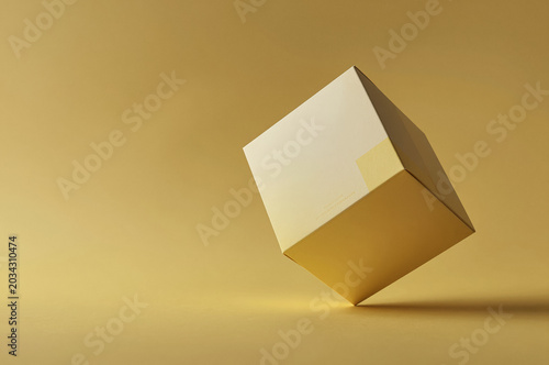 Cube levitates within a monochromatic yellow studio space through precise positioning. This matte cardboard geometry casts a soft shadow against the seamless satin surface underneath.