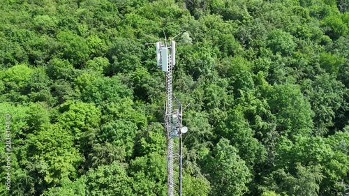 Cellular Communication Tower Above Dense Green Forest Landscape