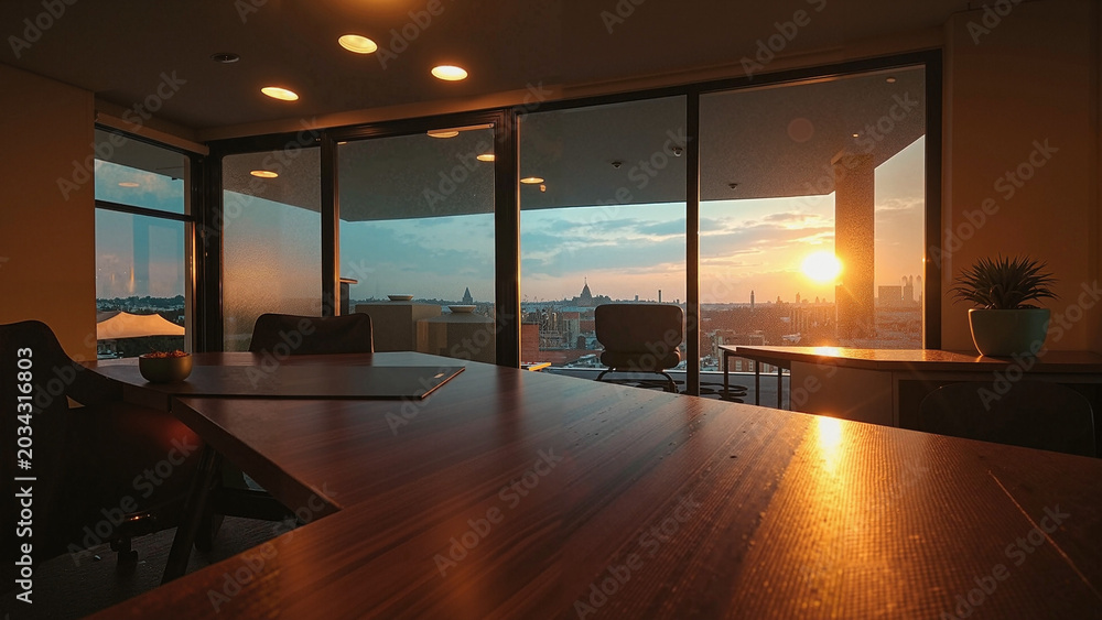 Fototapeta premium Executive Conference Room with Wooden Desk and Sunset City View