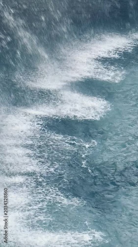 Water sprays upward in curved lines over deep blue sea