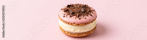 colorful ice cream sandwich cake pink frosting chocolate shavings smooth pastel pink background soft