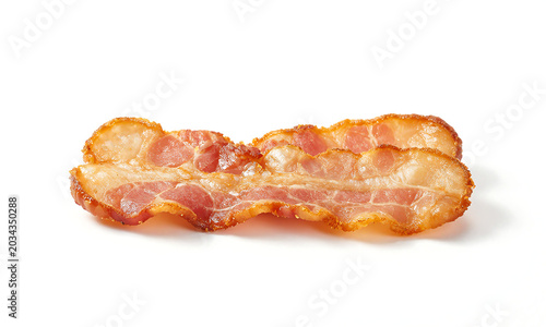 Фотография crispy fried bacon strip laid flat spotless white studio backdrop soft diffused