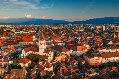 Photos Aerial sunset view of the Great Square in Sibiu Romania, showing historic buildings, the Catholic and Lutheran Church, and the council tower, sunset landscape