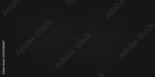 Tableau sur toile Black chalkboard background with subtle chalk dust texture and faint streaks for design overlay