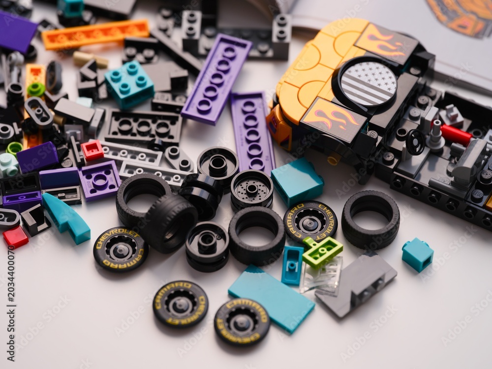Obraz premium Tambov, Russian Federation - January 01, 2026 Lego Speed Champions Nascar Next Gen Chevrolet Camaro car kit build in progress with bricks, blocks, pieces, tires and instructions