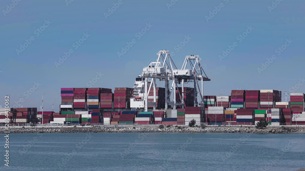 Naklejka premium Seaport with operating cranes and stacked containers