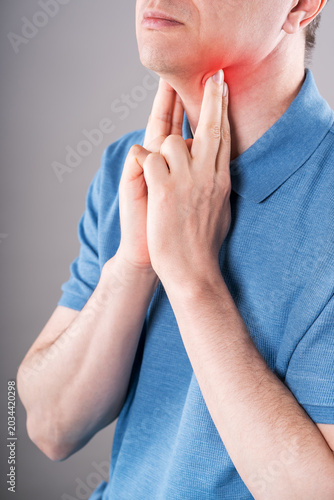 Bild auf Leinwand Thyroid gland inflammation, sore throat and cough, man with neck pain on gray ba
