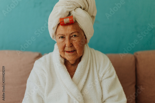 Tableau sur toile Senior woman with hair wrapped in a towel after shower.