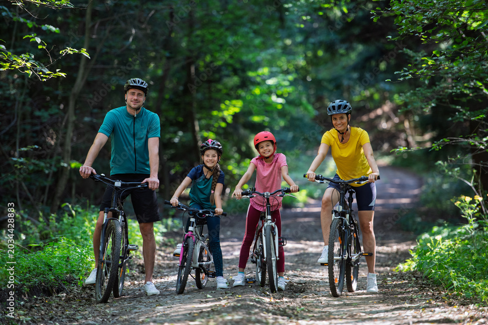 Fototapeta premium Active family enjoying biking adventure in scenic landscape.