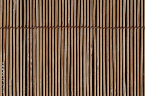 Vertical straw reed mat with rope seam detail, natural handcrafted texture ideal for sushi menus, spa themes, eco packaging and Asian style design