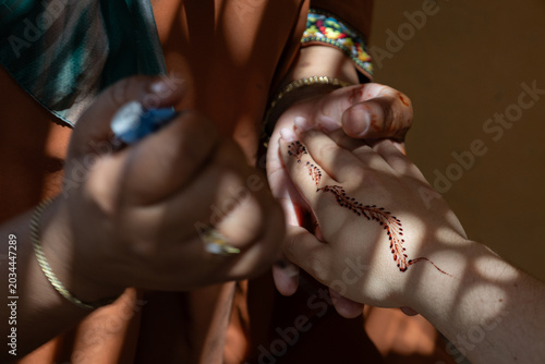 Cultural Beauty Ritual with Traditional Henna Painting on Female Hand