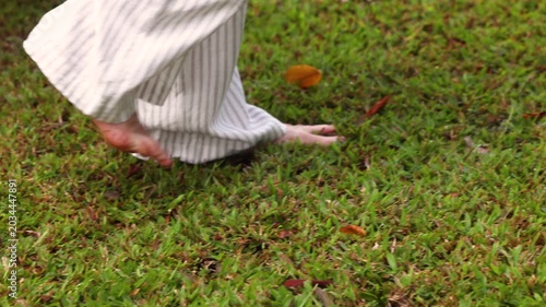 Barefoot walking on grass earth connection ecology lifestyle concept