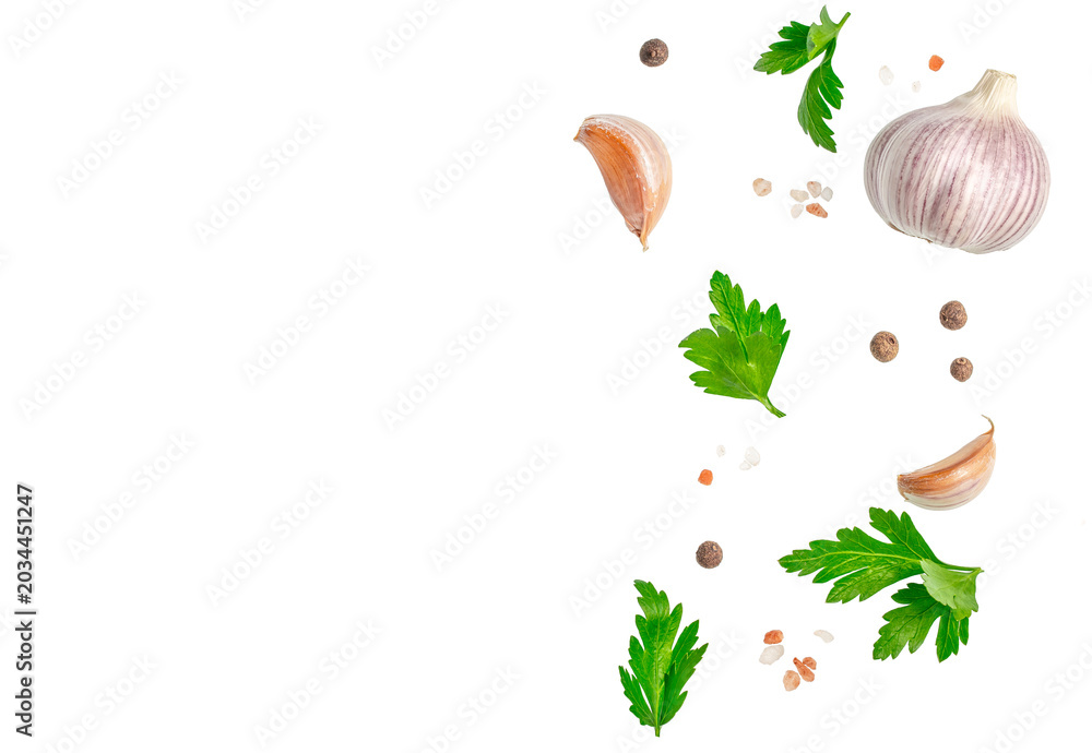 Fototapeta premium Garlic parsley peppercorns and salt arranged as food border isolated background for menu design recipe or advertising.