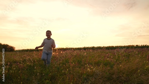Photography Boy running in a field at sunset, Child enjoying nature outdoors, Summer evening