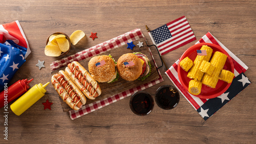 Schilderij op canvas Fourth of July barbecue food flat lay with burgers hot dogs and corn