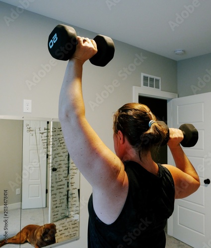 Tableau sur toile Woman Doing Video Workout in Home Gym - Home Fitness Exercise Weightlifting Heal